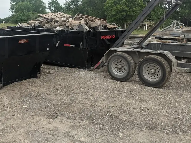 Dumpsters filled with scrap lumber and debris