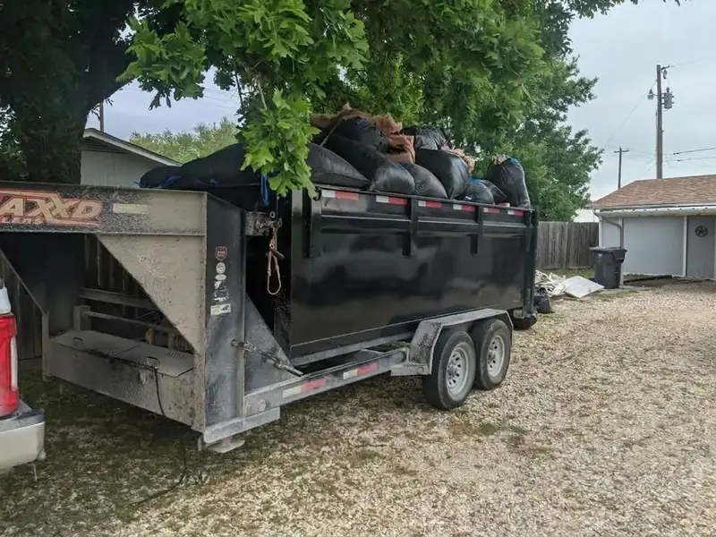 Dumpster trailer loaded with bagged trash