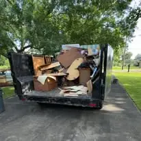 Trailer loaded with broken furniture and cardboard boxes