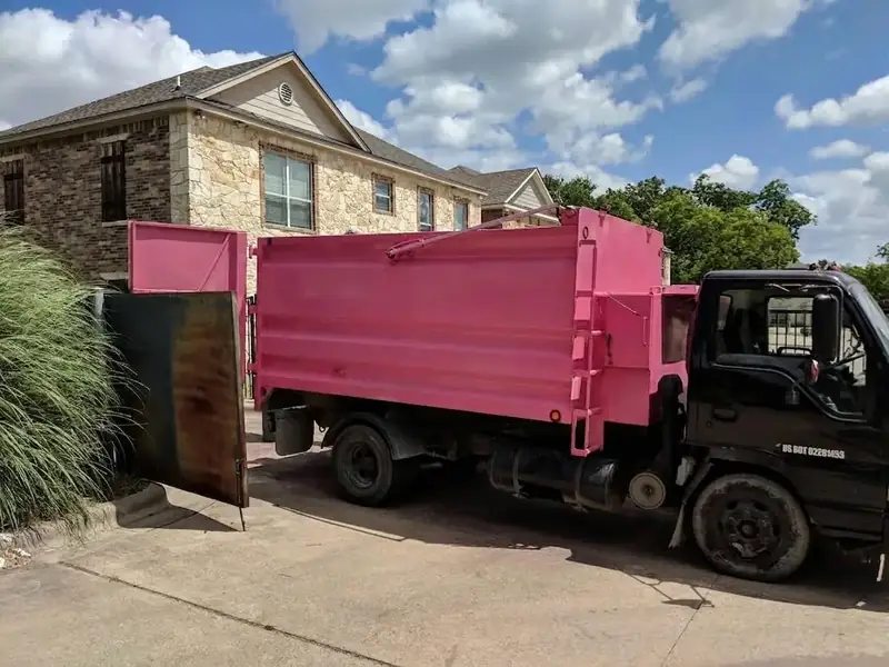 Junk hauling truck backing into a Homestead driveway